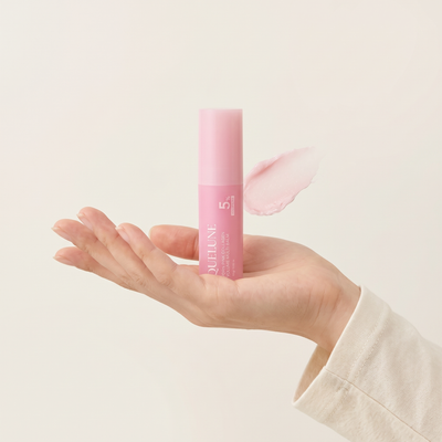 The balm held in an open palm to show its size